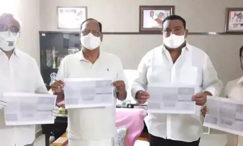 TS Legislative Council Chairman Gutha Sukender Reddy releasing brochures of Mahatma Gandhi’s 150th Jayanthi Utsav at his residence in Nalgonda on Friday. GCOT member MV Gona Reddy also seen