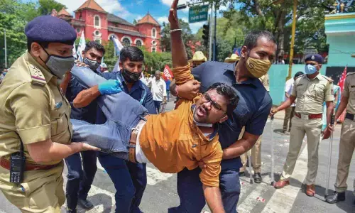Members of various farmer organizations being detained by the police during Bharat Bandh, a protest against the farm bills passed in Parliament recently, in Bengaluru