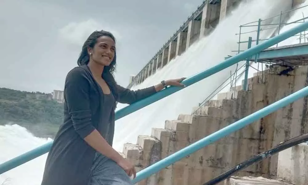 World badminton champ P V Sindhu posing for a photograph against the backdrop of the mighty Nagarjuna Sagar dam which provided a feast to onlookers’ eyes as 20 of its crest gates were opened due to heavy inflows on Sunday
