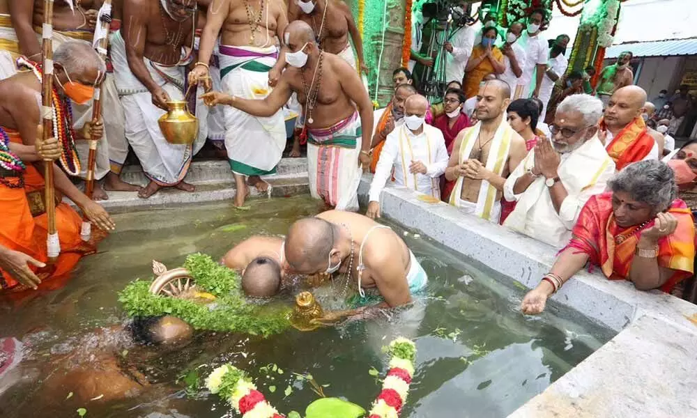 Priests performing Chakra Snanam at mini Pushkarini at Tirumala on Sunday to mark the conclusion of the nine-day Srivari Brahmotsavams