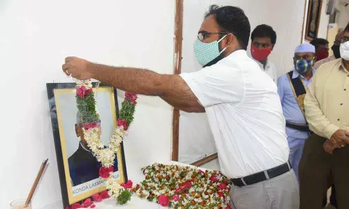 District Collector  K Shashanka garlanding the photo of Konda Laxman Bapuji at the Collectorate conference hall in Karimnagar on Sunday