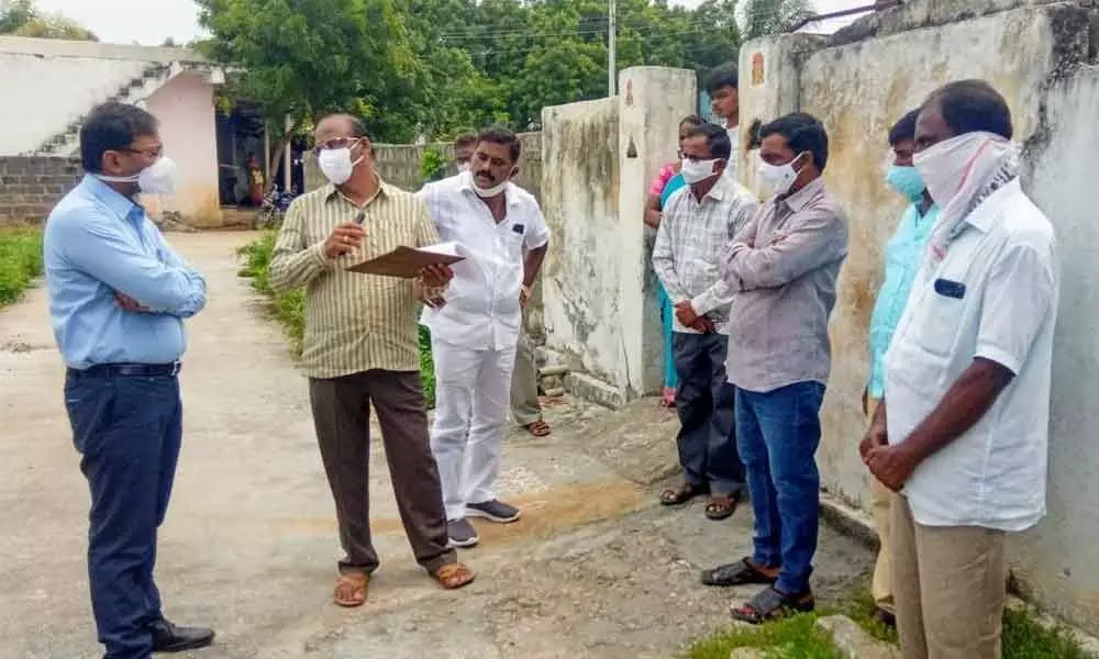 Collector T Vinay Krishna Reddy enquiring the staff during the survey of non-agriculture lands in Suryapet town on Tuesday