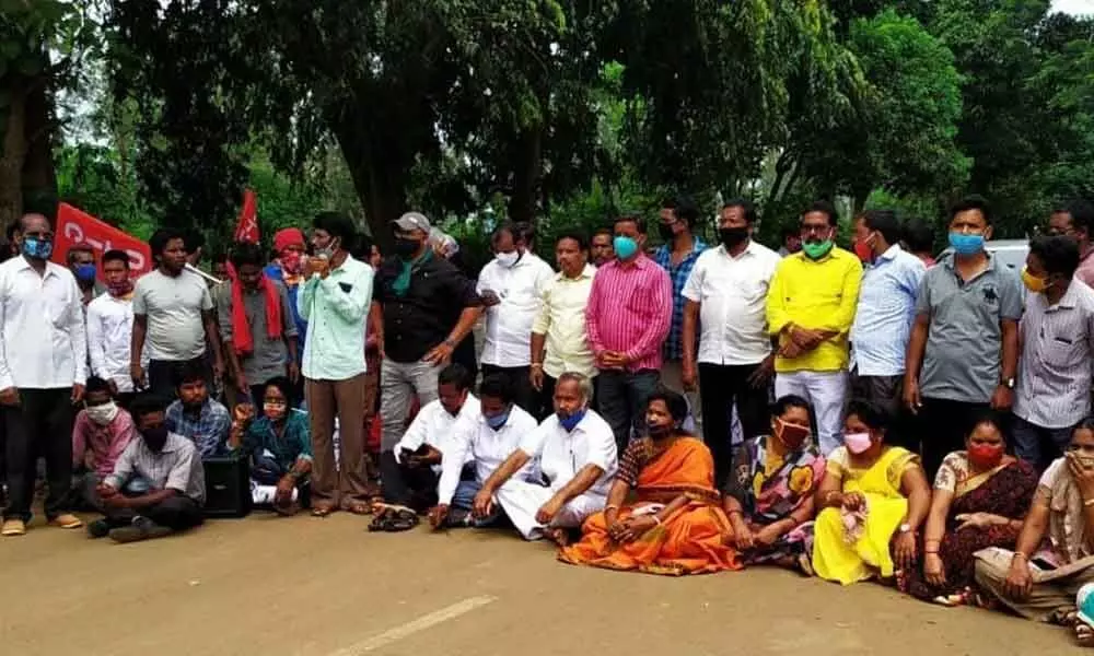 Tribal activists and representatives of various parties staging a protest in Visakhapatnam on Tuesday
