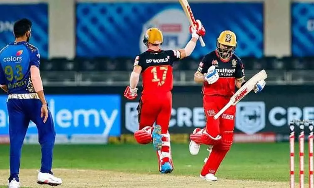 Royal Challengers Bangalore batsmen AB de Villiers and Virat Kohli celebrate after winning a match against Mumbai Indians