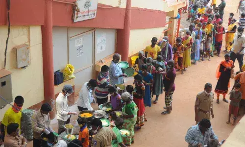 Municipal Corporation employees distributing food to flood victims