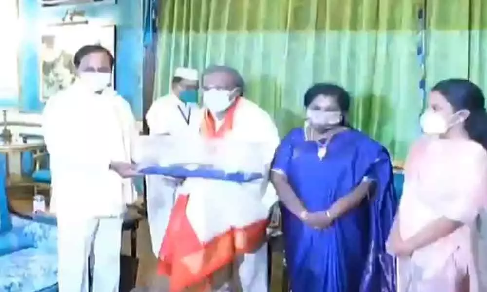 CM KCR felicitates governors husband for bagging Dhanwantari award
