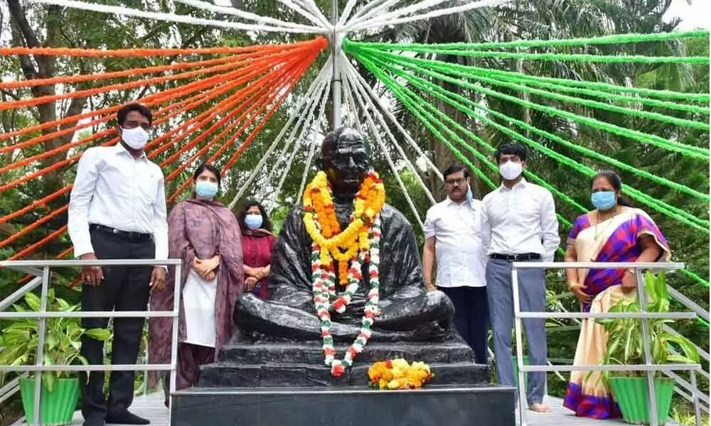 East Godavari District Collector D Muralidhar Reddy, Joint Collectors G Lakshmisha and G Rajakumari paying tributes to Mahatma Gandhi in Kakinada on Friday