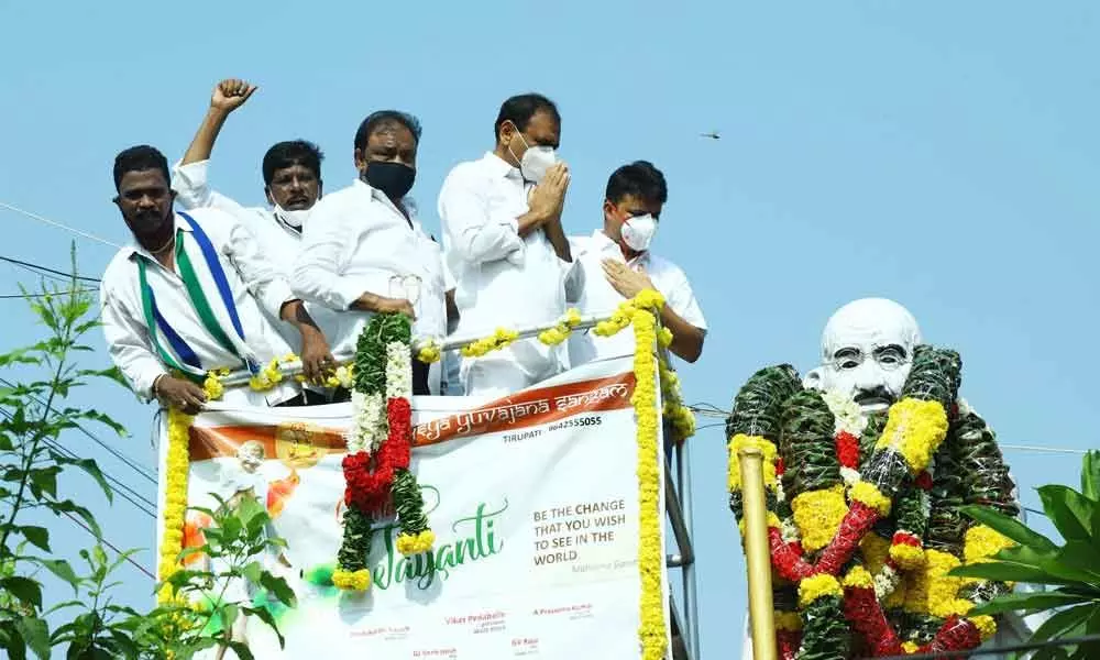 MLA Bhumana Karunakar Reddy and Municipal Commissioner P S Girisha garlanding Mahatma Gandhi statue in Tirupati on Friday to mark his 151st birth anniversary