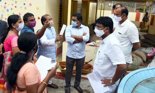 Education Minister Audimulapu Suresh enquiring about the progress of Naadu-Nedu works with district officials during  his visit to ZP High School in Kankipadu on Friday