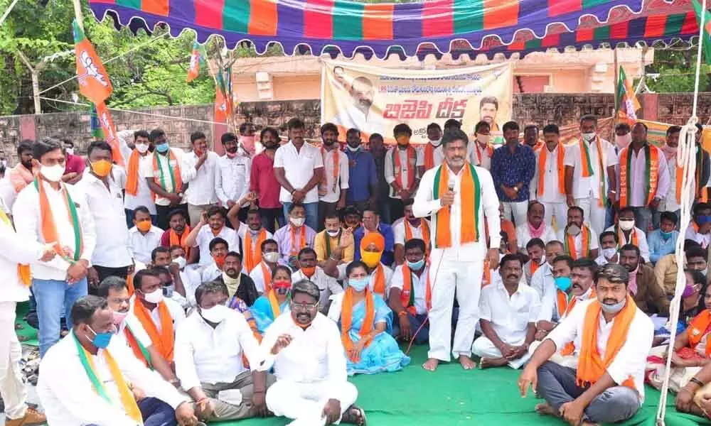 BJP District President G Krishna Reddy speaking at the dharna in front of the Collectorate in the district on Saturday