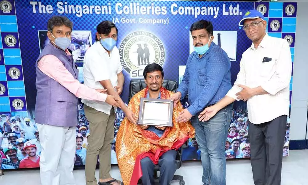 G CoT representatives presenting an award to SCCL Director Balaram at Singareni Bhavan in Hyderabad on Sunday