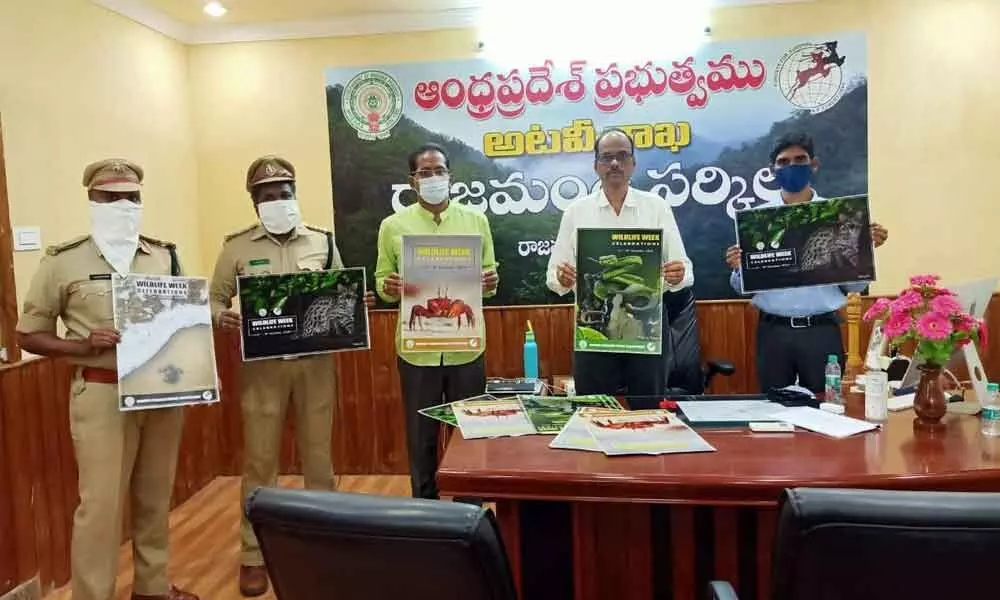 Rajahmundry Circle Forest Conservation Officer N Nageswara Rao releasing the Wildlife Week wall poster in Rajamahendravaram