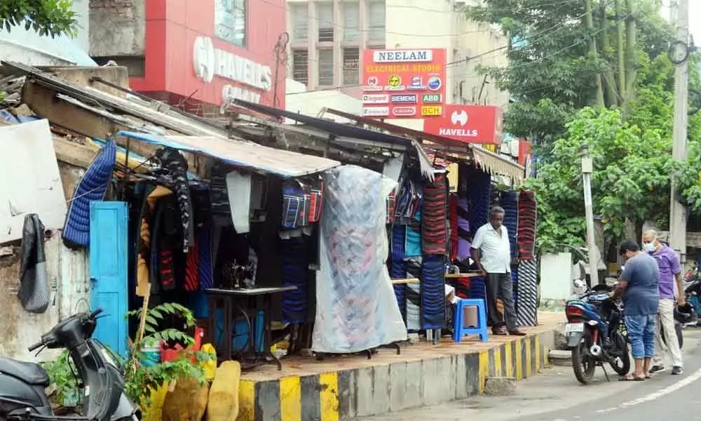 Small time vendors occupying footpath to run their business at Dabagardens in Visakhapatnam, posing a challenge to the pedestrians to pass through  	Photo: A Pydiraju