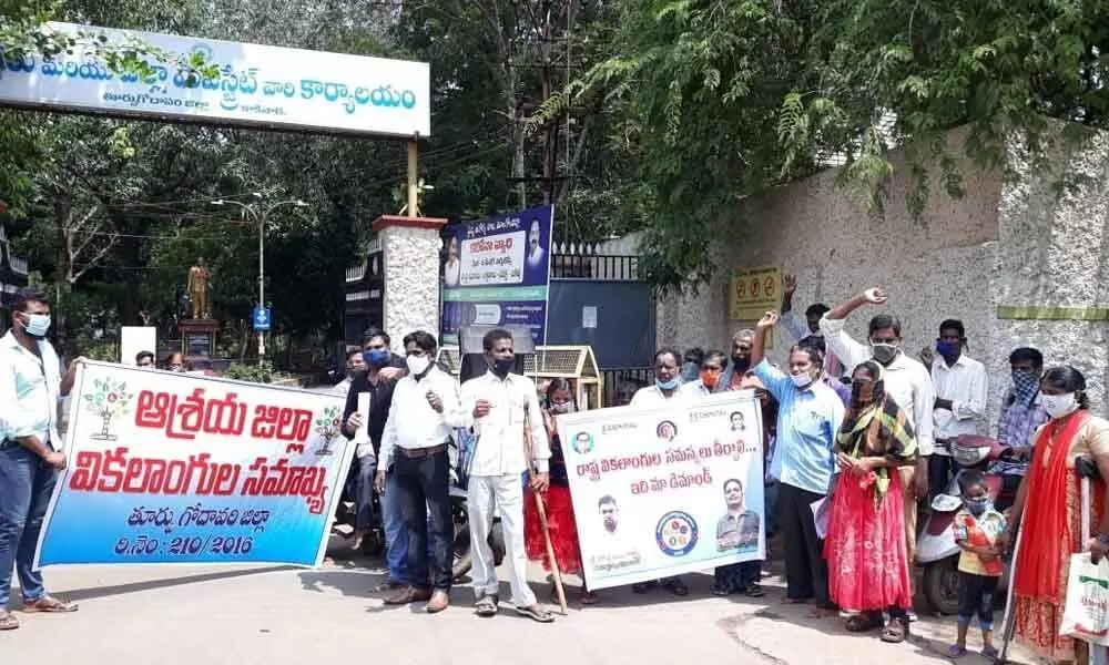Differently-abled persons staging a dharna in front of the Collectorate in Kakinada on Tuesday
