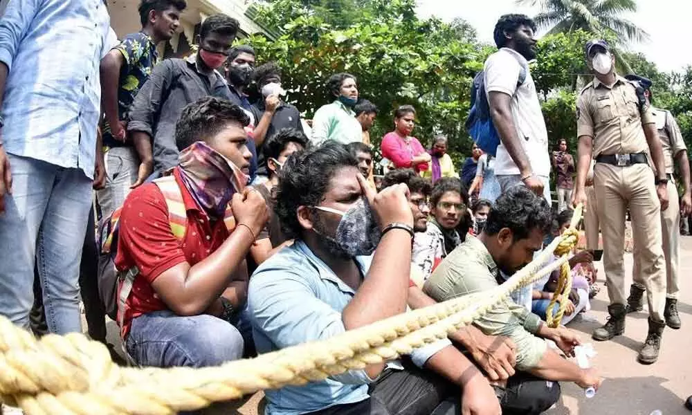 AU students and SFI activists staging a protest in Visakhapatnam on Wednesday