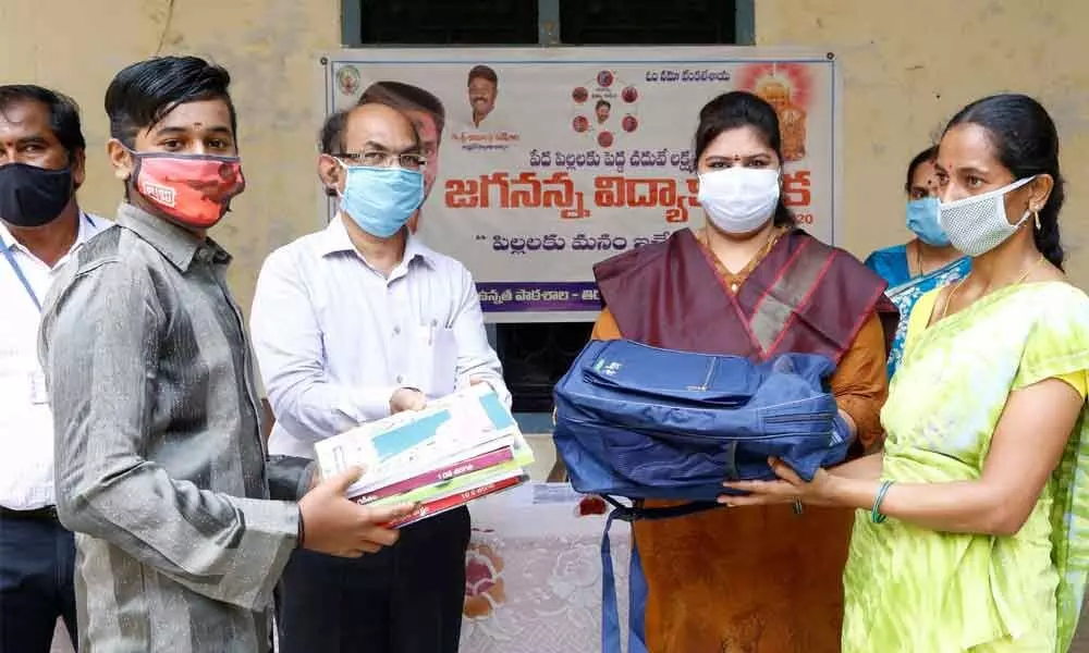 TTD JEO Sada Bhargavi distributing Jaganna Vidya Kanuka school kit to a student in a TTD School in Tirupati