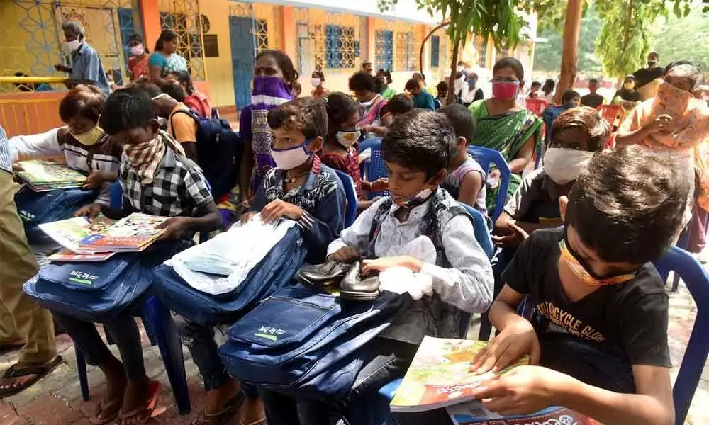 Students with bags and books received as part of Jagananna Vidya Kanuka at GVMC primary school