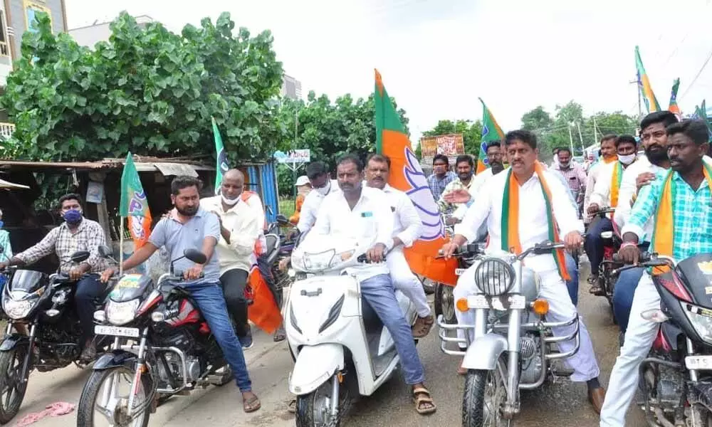 BJP district president Galla Satyanarayana and party leaders taking out motorbike rally in Bonakal on Thursday