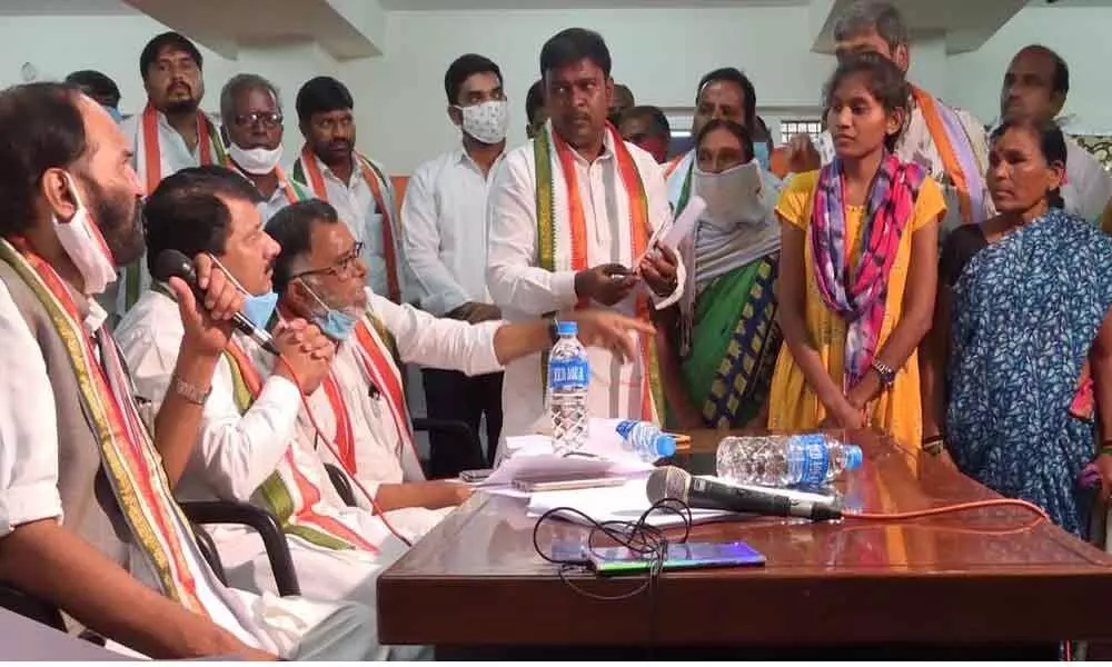 TPCC president and Nalgonda MP N Uttam Kumar Reddy interacting with a Dalit victim at a programme organised by Congress SC Cell in Gandhi Bhavan on Sunday. Congress SC Cell leader Preetham is also seen