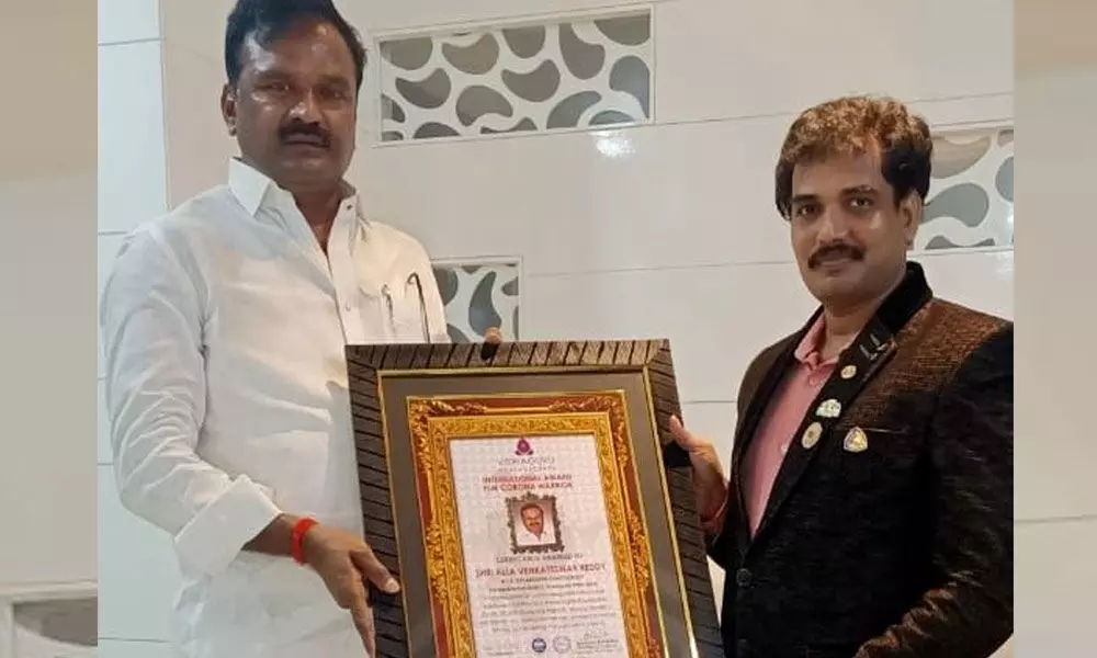 Devarkadra MLA Alla Venkateshwar Reddy receiving Corona Warrior Award from Vishwaguru World Record representative