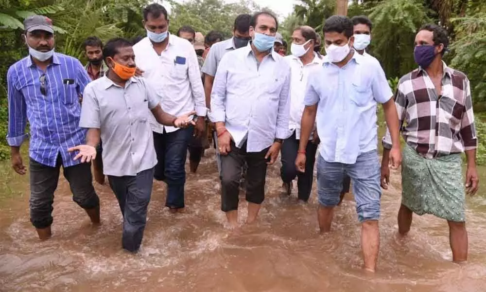 Agriculture Minister Kurasala Kannababu visiting flood-affected areas in Vakada village on Monday
