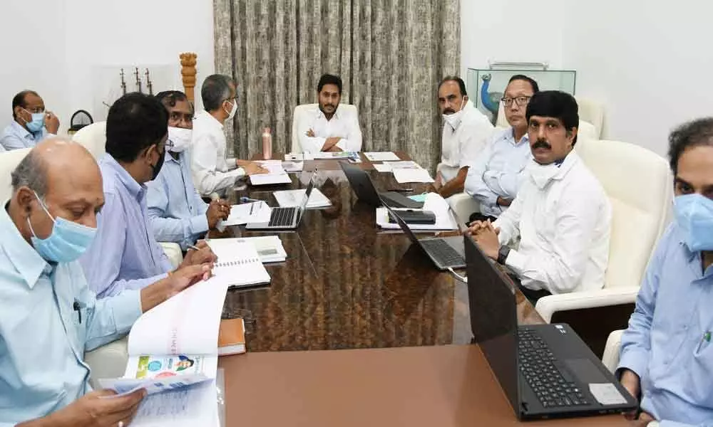Chief Minister Y S Jagan Mohan Reddy holding a review on energy sector at his camp office in Tadepalli on Monday. Energy Minister B Srinivas Reddy, advisors and officials are seen.