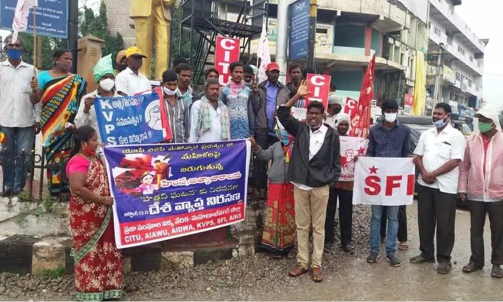 Leaders of CITU, SIF and KVPS staging a protest against the BJP government, at Ambedkar crossroad in Mahabubnagar on Tuesday