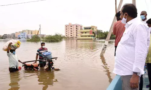 Agriculture Minister Kurasala Kannababu visiting flood prone areas in Kakinada Rural on Thursday