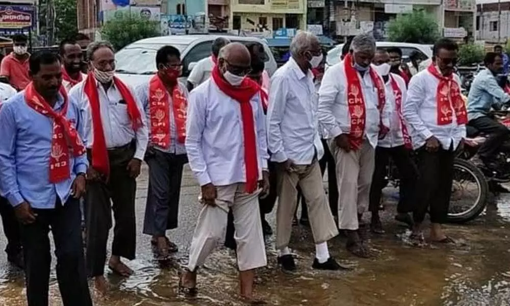 CPI State secretary Chada Venkat Reddy along with other leaders inspecting flood-affected areas in Chotuppal town on Friday