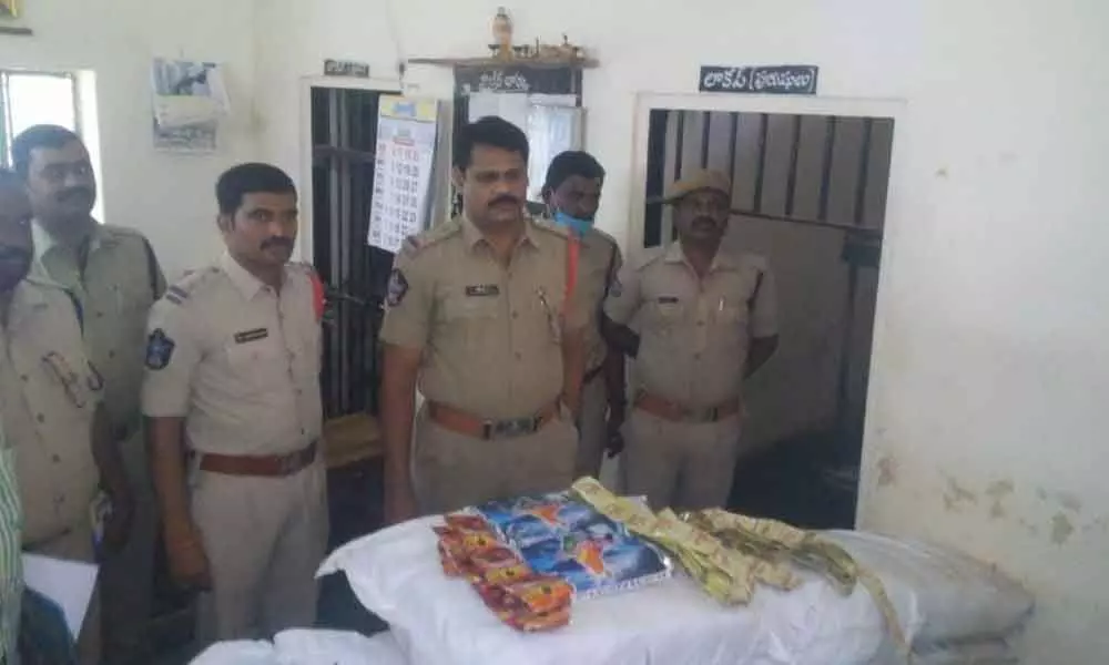 Atmakur Circle Inspector B R Krishnaiah, Sub-Inspector Nagendra Prasad and his team presenting seized gutka bags before media in Kurnool on Friday