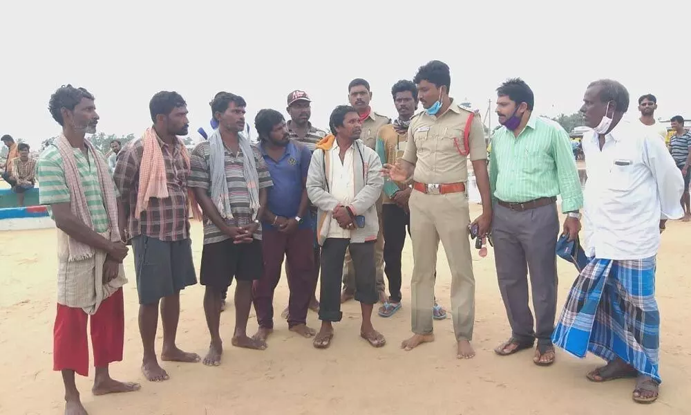 The seven fishermen from Kakinada explaining their plight to the police and fisheries officials at Vadarevu on Friday