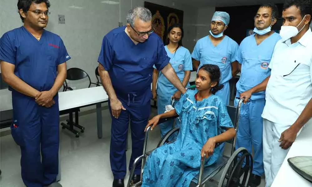 BIRRD Director Dr M Madan Mohan Reddy and other doctors with the girl C Indu who has undergoine spine and rehabilitation surgery in the hospital