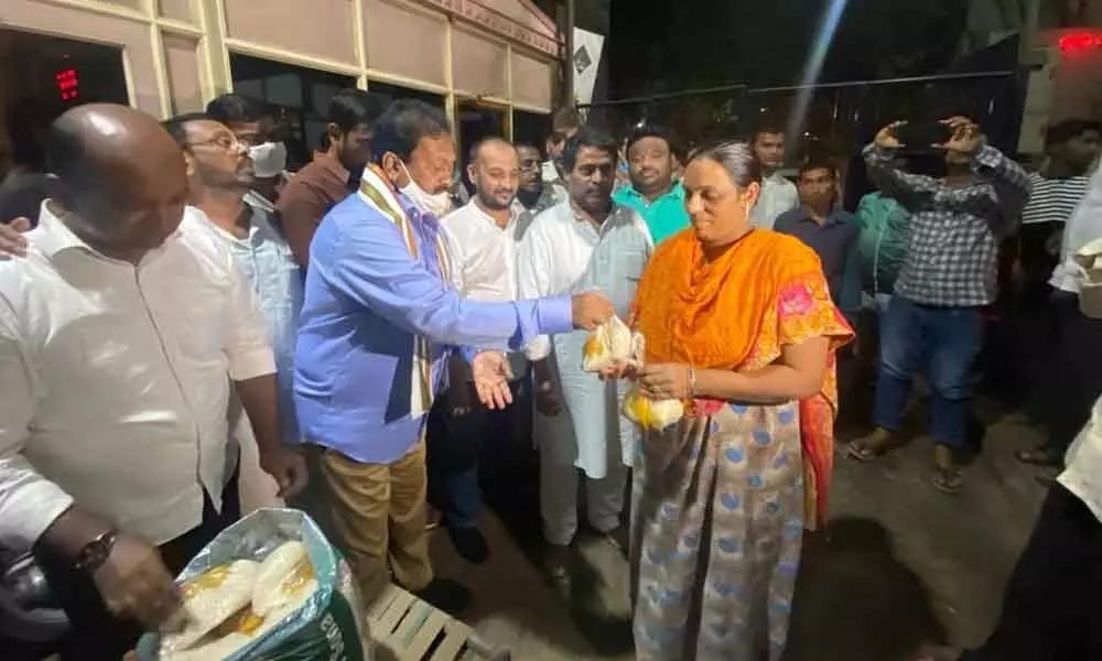 Senior Congress leader Mohammed Ali Shabbir distributing relief material in the flood-hit Malakpet area of Hyderabad on Sunday