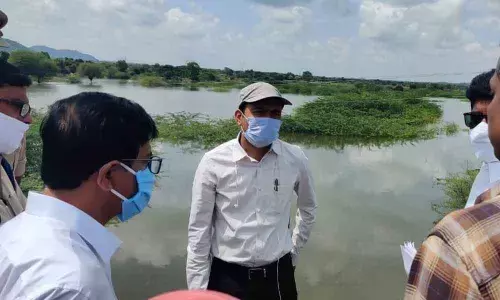 District Collector Prashanth Jeevan Patil interacting with the officials during his tour to Neredugomma mandal on Sunday