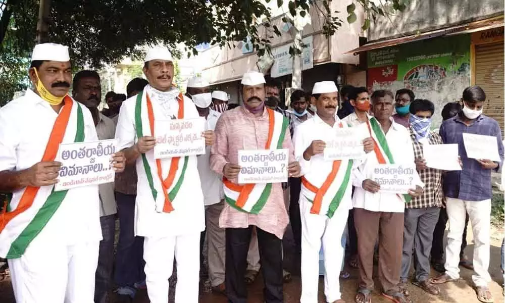 Congress activists staging a dharna demanding the Centre to resume international flight service from Tirupati International airport, at Renigunta mandal office on Monday