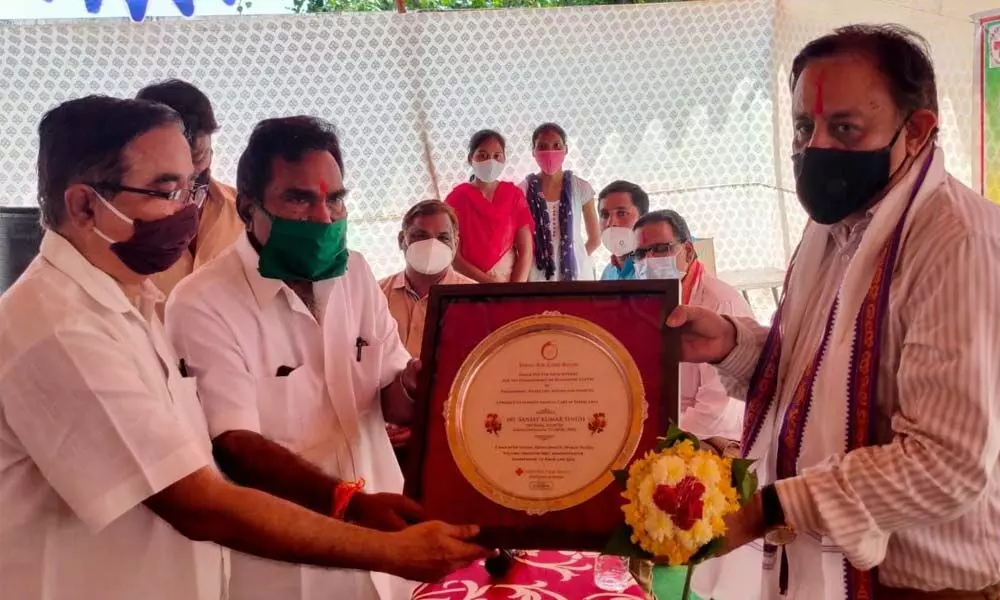 Red Cross representatives presenting a memento to PSPD Chief Executive Officer Sanjay Kumar Singh at Bhadrachalam town on Monday