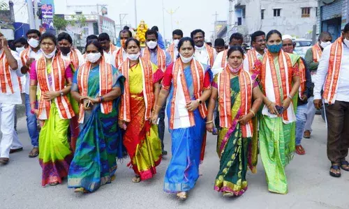 Municipal chairperson Ramatheerthapu Madhavi and others participating in Shobha yatra in Vemulawada on Thursday
