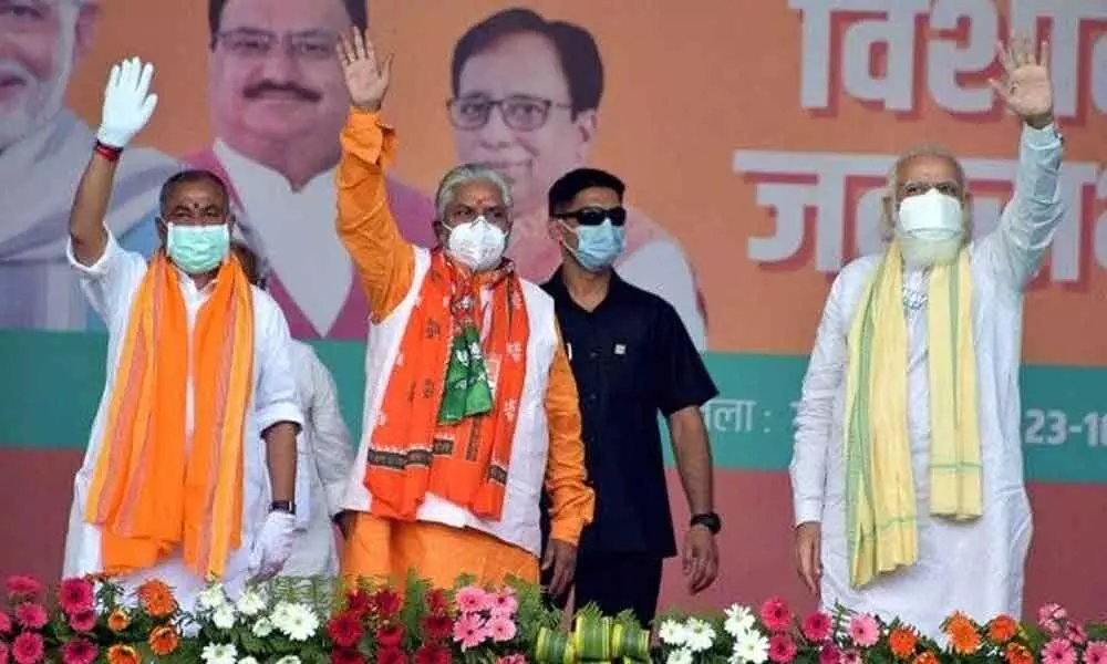 Prime Minister Narendra Modi waves to his supporters during an election rally, at Gandhi Maidan in Gaya.