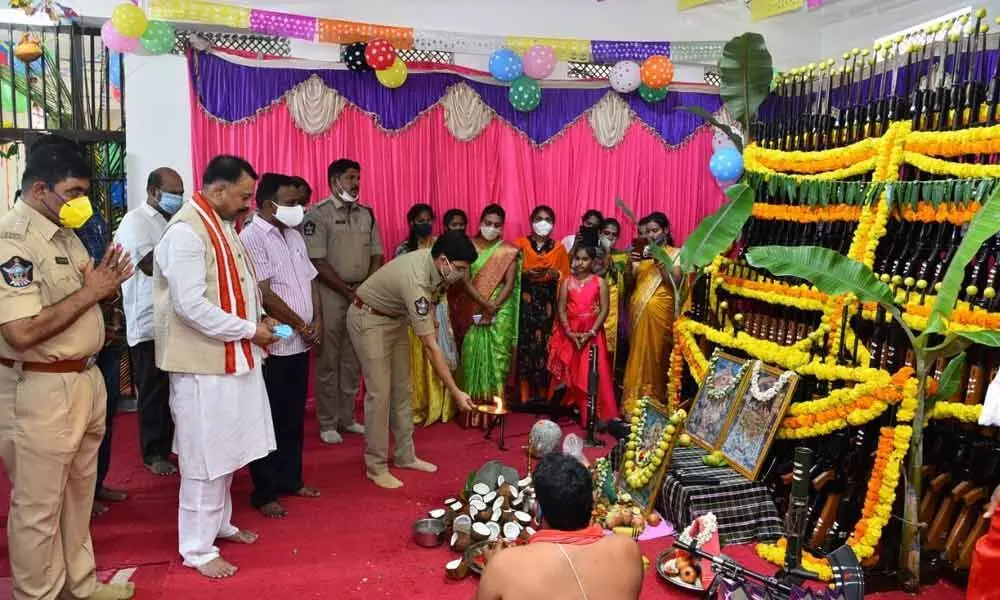Police performing Ayudha Puja to the arms and ammunition at the District Police Office in Kurnool on Saturday