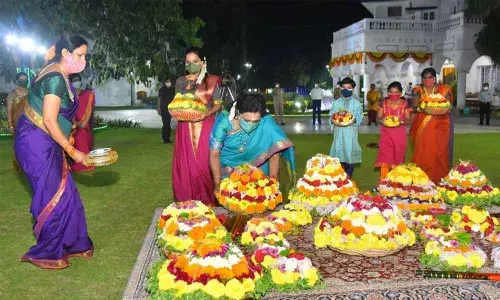 Governor Dr Tamilisai Soundararajan, along with her family members, celebrating Bathukamma festival on the premises of Raj Bhawan in Hyderabad on Saturday