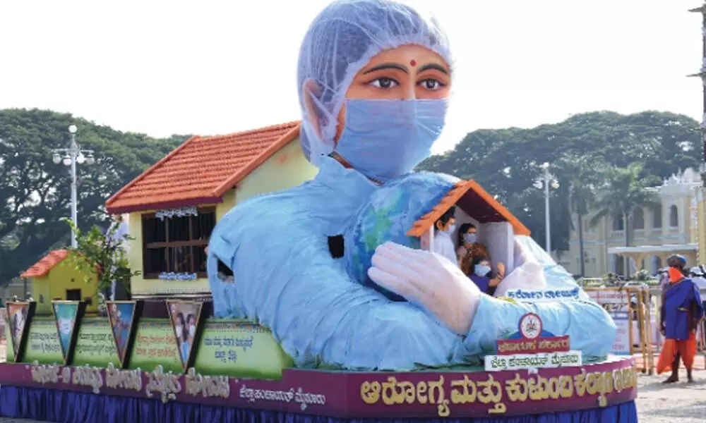 The tableau by health department and Zilla Panchayat depicts a corona warrior holding a family in her protective arms