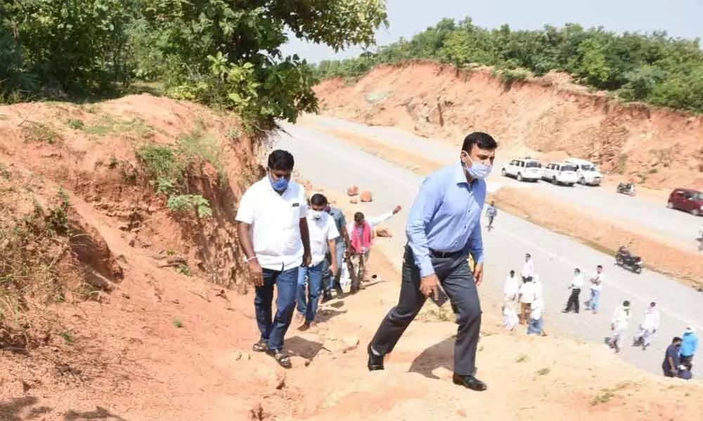 District Collector Dr A Sharath inspecting road widening works of NH 161 at Masanpalli