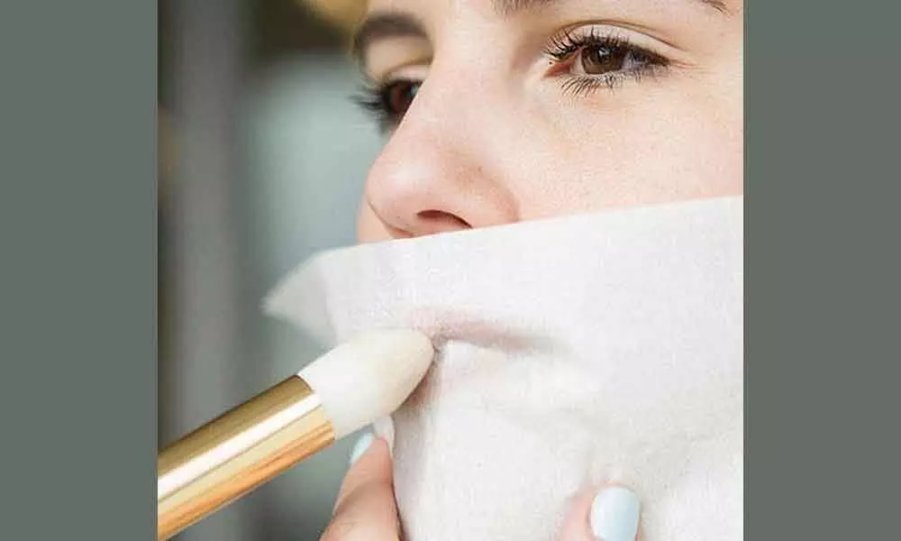Set your lipstick with powder through a tissue