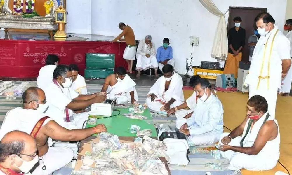 Temple Executive Officer K S Rama Rao inspecting the counting of hundi collections at Srisailam temple on Thursday