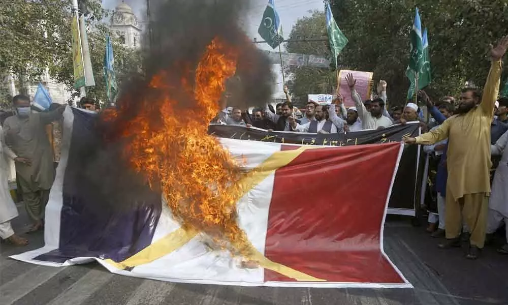 As anger rises, Muslims protest French cartoons