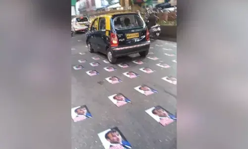 Police remove posters of Macron pasted on Mumbai road