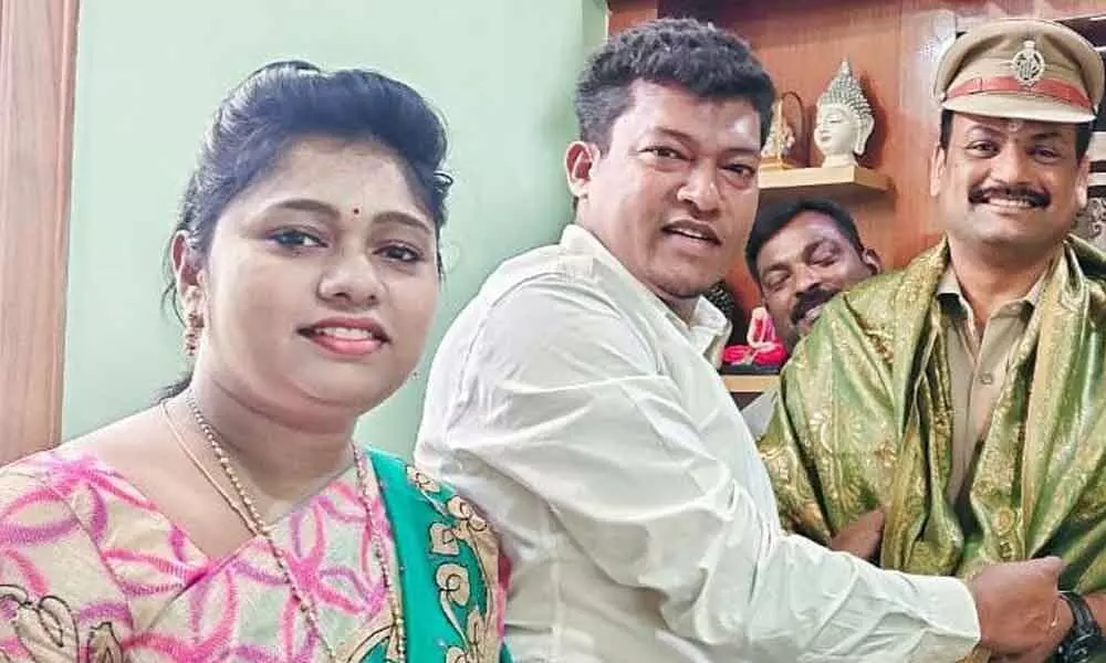 Minister for Animal Husbandry Seediri Appala Raju and his wife Sridevi felicitating Kasibugga Circle Inspector Guggilapu Srinivasa Rao at his camp office