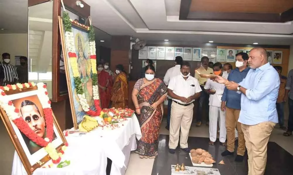 TUDA Chairman Chevireddy Bhaskar Reddy performing puja to the portraits of Telugu Thalli and Potti Sriramulu on the occasion of State Formation Day celebrations