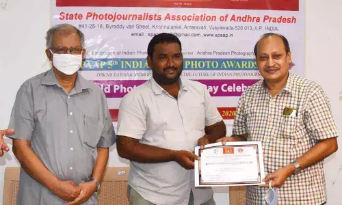‘The Hans India’ staff photojournalist Y Vinay Kumar receiving award from MVS Sarma, former MLC and editor of Prajasakti, in Vijayawada on Sunday