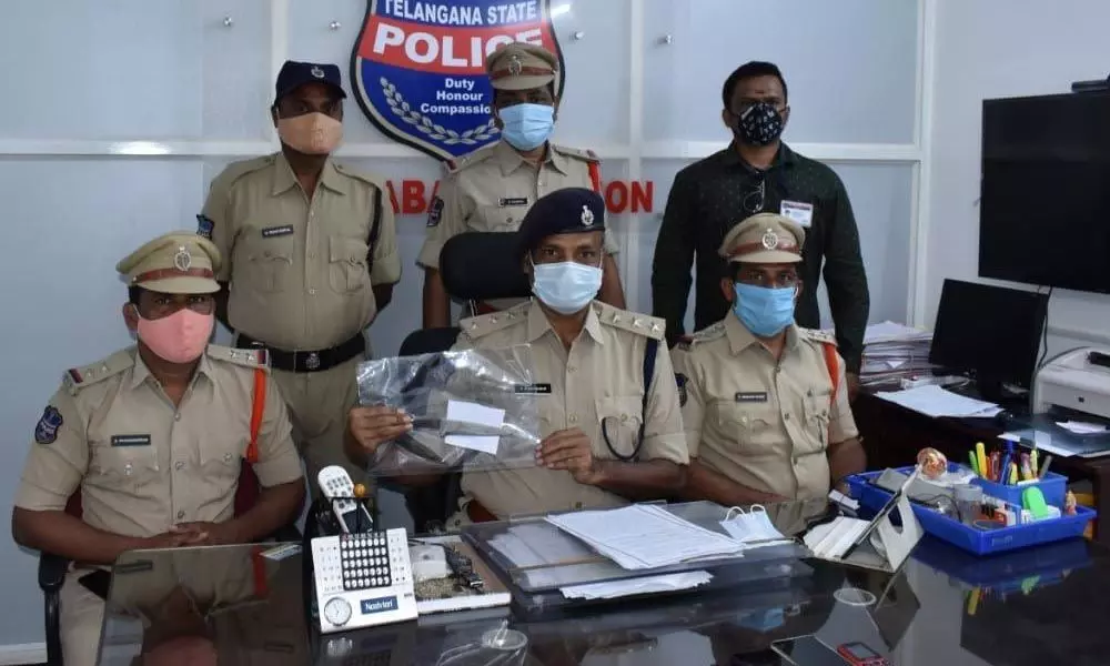 Police showing the weapons used to murder J Narayana, at a press meet in Nizamabad on Monday